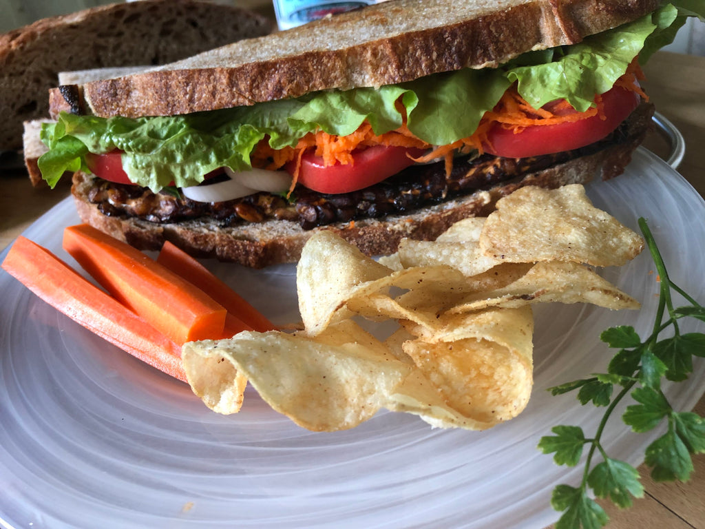 https://naturallifestylemarket.com/cdn/shop/articles/chef-toms-sweet-and-sour-tempeh-sandwich-scaled_1024x1024.jpg?v=1694616109