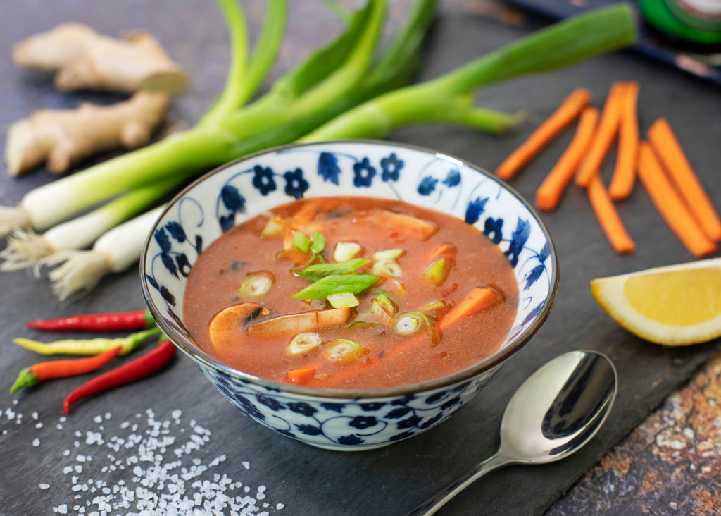 https://naturallifestylemarket.com/cdn/shop/files/bowl-of-soup-on-table-surrounded-by-vegetables_1024x1024.jpg?v=1666443064